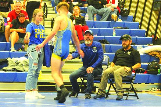 Brandon Lewis gets congratulations from his father, assistant coach Richie Lewis, and girlfriend Kaitlyn Sanders after pinning Union County’s Rodney Barnett in 1:02 in the 138-pound semifinal match. At right is Palatka head coach Josh White. (MARK BLUMENTHAL / Palatka Daily News)