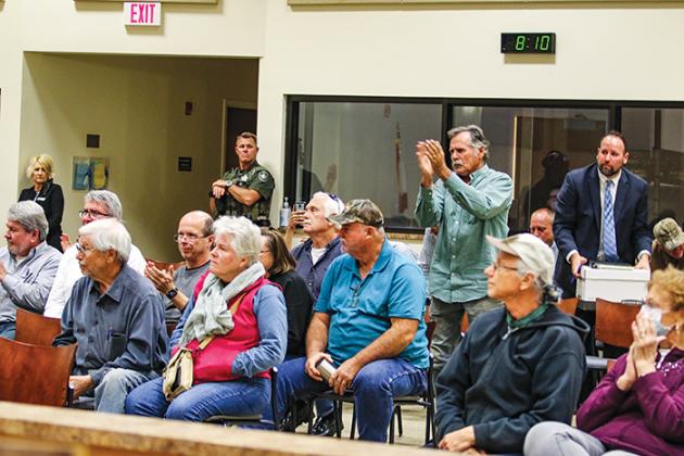 Putnam County residents clap in approval after the Zoning Board of Adjustment votes down a special use permit application to distribute biosolids a Lake Como property.