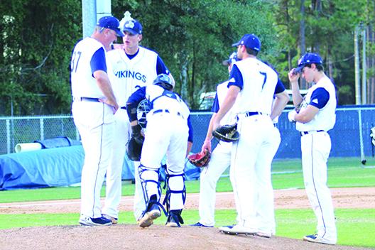 St. Johns River State pitcher Tanner Bauman (second, left) is talked to by head coach Ross Jones (37) during a conference on the mound during Thursday’s game. (MARK BLUMENTHAL / Palatka Daily News)