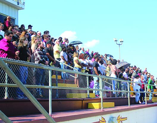 The crowd stands as Clarence "Pooh Bear" Williams' family and friends enter Wisnoski Field at Wiltcher Stadium Saturday. (MARK BLUMENTHAL / Palatka Daily News)