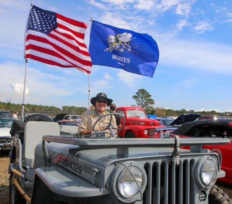 Mark Hooper, a Jacksonville man, smiles Saturday in his 1952 M38 Jeep that he fully restored. 