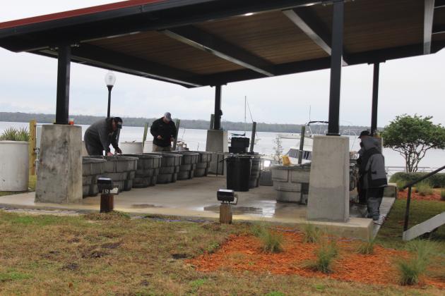Workers put together the tubs for the fish backstage Tuesday for the upcoming AFTCO Bassmasters Elite at the St. Johns River tournament. (MARK BLUMENTHAL / Palatka Daily News)