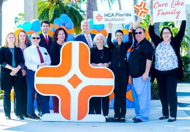 Physicians and colleagues at HCA Florida Fawcett Hospital in Port Charlotte celebrate their parent company’s rebrand with a larger-than-life Diamond Plus mark.