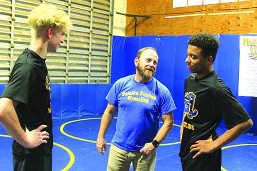 Palatka wrestling coach Josh White shares a laugh with state qualifiers Brandon Lewis (left) and Mikade Harvey before Wednesday’s practice. (MARK BLUMENTHAL / Palatka Daily News)