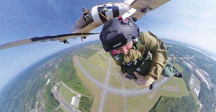 Round Canopy Parachuting Team - USA Treasurer John Hoffstetter leaps from a plane over Palatka recently in preparation to commemorate the D-Day anniversary in June.