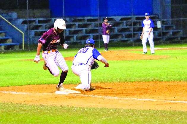 Crescent City’s Brian Carranza is out on a close play in the third inning as Palatka first baseman Tyler McInnis. (RITA FULLERTON / Special to the Daily News)