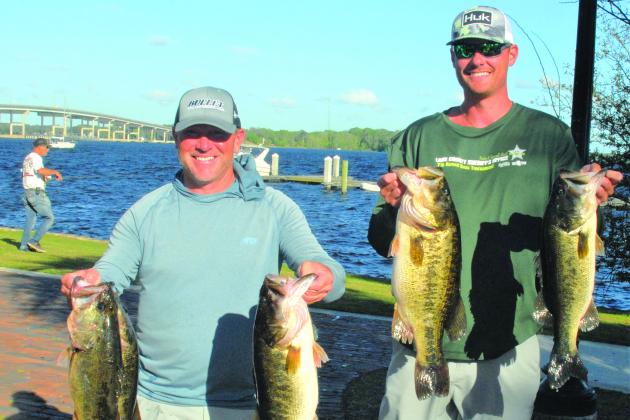 Jason Caldwell and Tyler Deruiter of Jacksonville  hold up their winning fish in the Xtreme Bass Trails at the Palatka Riverfront. (GREG WALKER / Daily News correspondent)