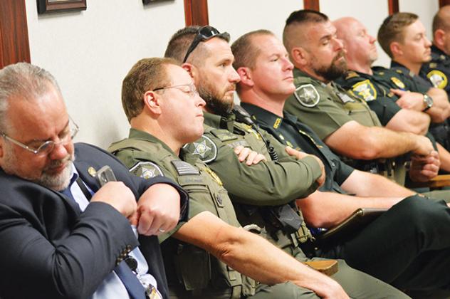 Sheriff Gator DeLoach, fourth from left, and other law enforcement officials listen as Hill responds to criticisms about the Palatka City Commission’s interactions with the police.