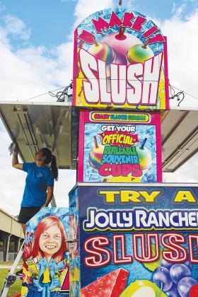 Christina Hockridge cleans the Polar Slush booth at the Putnam County Fairgrounds on Monday to prepare for the first day of the fair Friday.