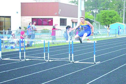 Palatka’s Braeden Brauman clears a hurdle en route to winning the 300-meter intermediate hurdles during Tuesday’s Senior Night event at home. (MARK BLUMENTHAL / Palatka Daily News)