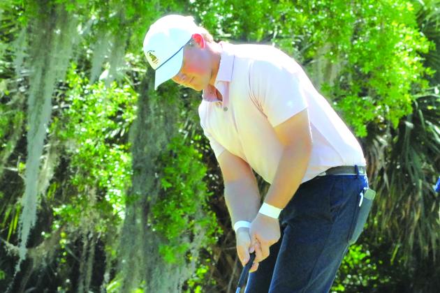 After a 300-plus drive on the No. 11 hole Sunday,Sean Butscher of Tallahassee makes birdie at the Florida Azalea Amateur Tournament. (GREG WALKER / Daily News correspondent)