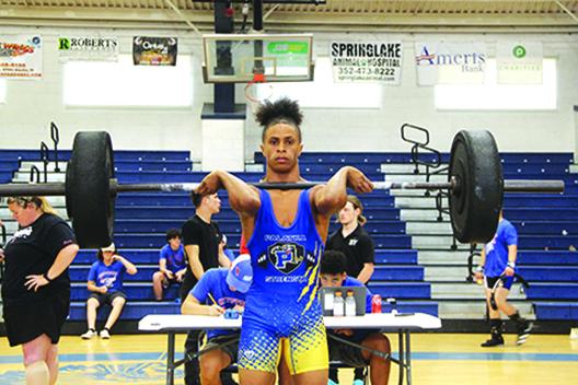 Palatka’s Ishmael Foster successfully lifts his clean-and-jerk attempt during the District 7-1A championship at Keystone Heights. Foster took second in the 119-pound class. (COREY DAVIS / Palatka Daily News)