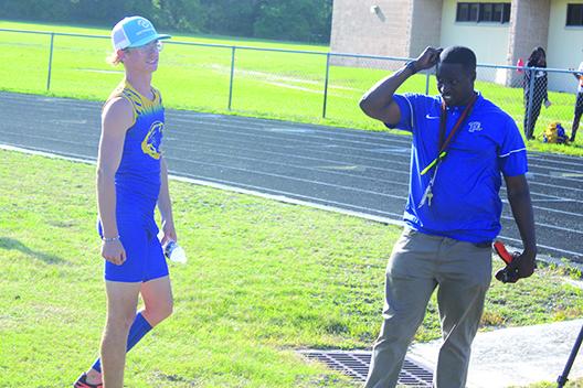 Palatka’s Hayden Newman, shown with head track coach Jarimy Passmore during last week’s Senior Night home meet, won the 100- and 400-meter races at Wednesday’s Stinger Invitational at St. Augustine High School. (MARK BLUMENTHAL / Palatka Daily News)