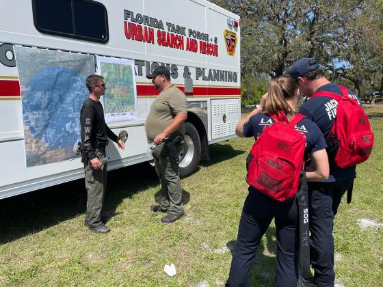 First responders coordinate search efforts near Jose Lara's home Monday.