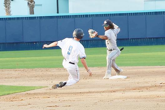 St Johns River’s J.J. Sousa (No. 9) attempts to break up a double play as Santa Fe second baseman Jevin Relaford throws to first base. (Rita Fullerton/Special to the Daily News)
