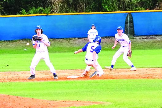 Palatka courtesy runner Corey Baggs steals second base as Peniel Baptist Academy’s Nick Fisher takes the throw in the fourth inning Friday. (RITA FULLERTON / Special to the Daily News)