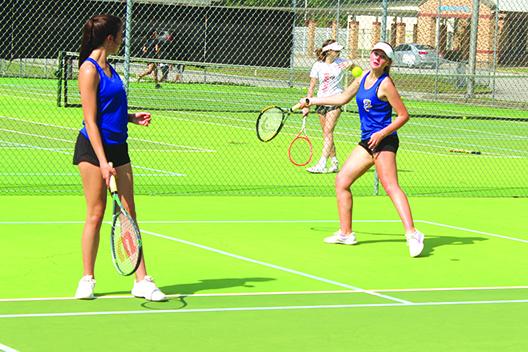 Palatka’s Elle Herrington (left) watches second doubles teammate Paige Griner return a shot during practice before a recent match. The pair will play together and as singles competitors in next week’s district tournament at Palatka. (MARK BLUMENTHAL / Palatka Daily News)