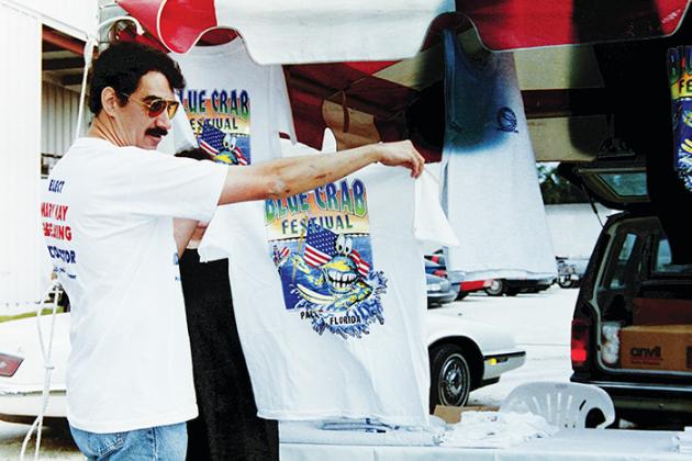A volunteer holds up a Blue Crab Festival shirt during the 1996 event.