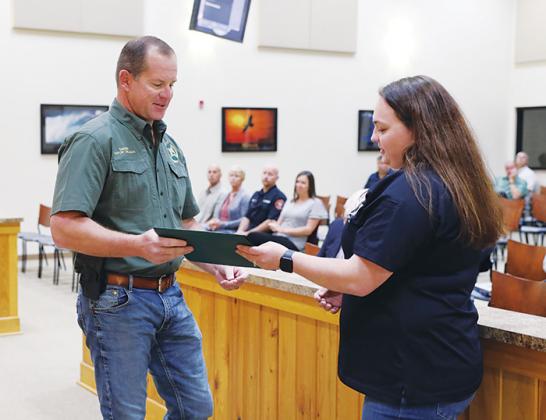 Putnam County Sheriff Gator DeLoach gives Cpl. Klarissa Fleming the Life-Saving Award on Tuesday for helping a victim in a domestic violence situation last month.