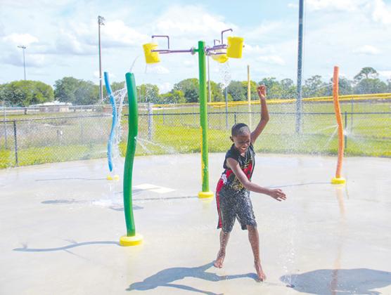 Ayden Coley hangs out at the Project P.L.A.Y. splash pad Monday as it reopened after being fixed in time for spring.