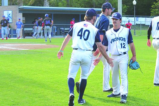 St. Johns River State pitcher and Palatka High product Layton DeLoach (12) gets congratulations from teammate Parker Stallard after an 11-8 win over Central Florida. (MARK BLUMENTHAL / Palatka Daily News)