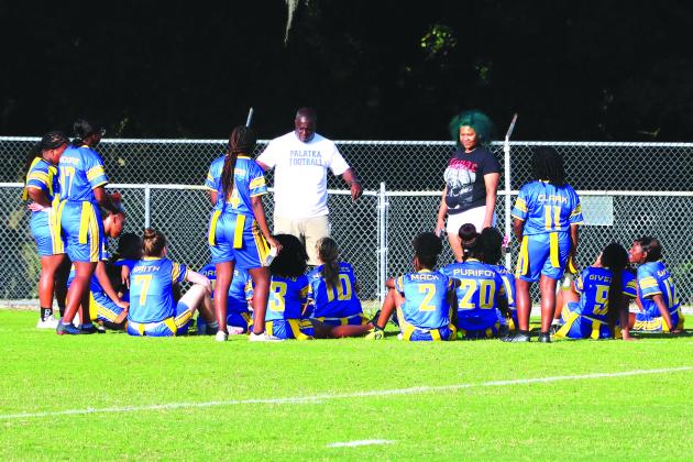 Palatka Junior-Senior High flag football assistant coach Lamar Purifoy (middle) talks to his team at halftime during Monday’s District 4-1A tournament win against Jacksonville Wolfson. The Panthers lost in the quarterfinal round to host Jacksonville Ed White Tuesday night, 39-0. (RITA FULLERTON / Special to the Daily News)