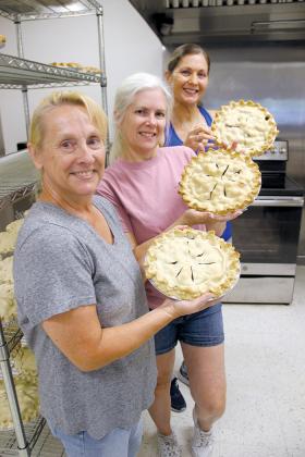 Volunteer kitchen crew members have been making blueberry pies and muffins for the past three days in preparation for Saturday’s Bostwick Blueberry Festival. From front to back are Heidi Hockenberry, Angela DeLettre and Dawn Rawls.