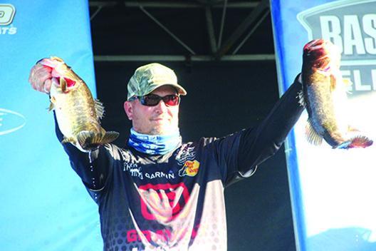 Cliff Prince shows off a couple of his catches during the second day of last year’s AFTCO Bassmaster Elite at the St. Johns River event. Prince finished seventh. (Daily News file photo)