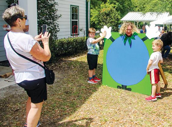 A family poses with the blueberry cutout Saturday during the Bostwick Blueberry Festival.