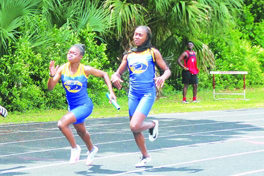 Palatka's Ymira Passmore (left) gets the baton from Khalia Wright during the team's winning 4x100 relay at the District 5-2A championship on April 21 at Palatka. (MARK BLUMENTHAL / Palatka Daily News)