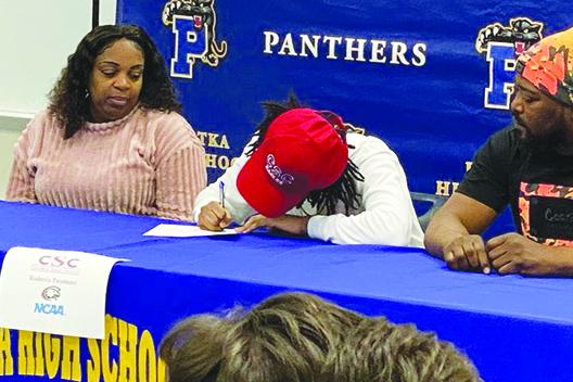 Palatka’s Roderris Passmore signs his letter of intent to attend Chadron State in Nebraska. Watching over the signing is his mother, Letichi, and father, Robert. (Photo courtesy of Palatka Football Facebook Page).