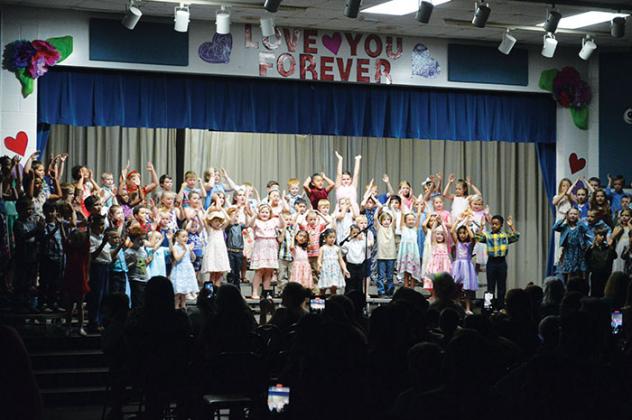 Mothers and other family members watch first graders at Jenkins Elementary School in Interlachen perform the “Love You Forever” Mother’s Day Program on Thursday evening.