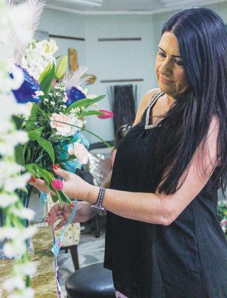 Kim Singletary, owner of Palm Florist in Palatka, perfects one of the shop’s Mother’s Day bouquets Thursday.