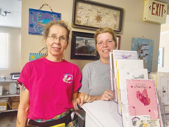 Mother’s Day cards sit on display for purchase at Shrimps R Us & More in Welaka on Thursday in front of employees Laura Cubbage and Robin Clementz.