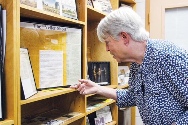 Cherie Register examines documents from her mother’s collection that is now housed in the Maragary Neal Jones Nelson Archives in Crescent City. The collection will be open to the public starting Saturday.