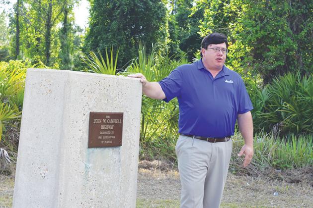 Matt Buckles, the Rotary Club of Palatka member who suggested the rededication, speaks to the crowd while standing next to Campbell’s memorial.