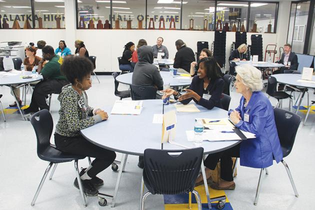 Interviewers speak to a student at Palatka High to prepare her for the job search.