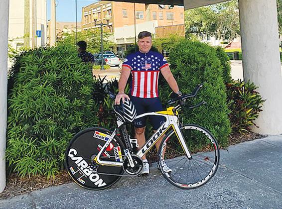 J.J. Gullett stands outside Gullett Title in Palatka as he prepares to go for a bicycle ride.