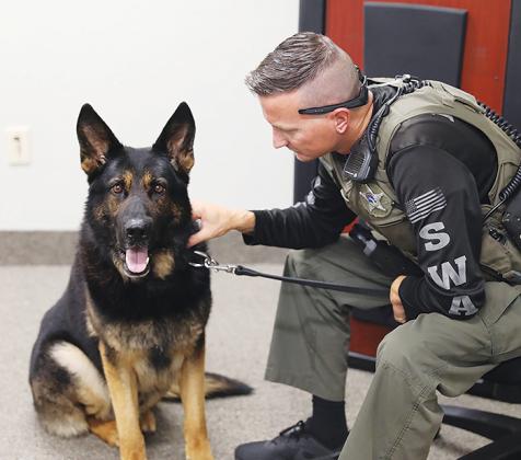 Putnam County Sheriff’s Office Lt. Kagen Butts says goodbye to his partner, K-9 Halo, on Monday as the German shepherd heads into retirement.