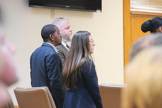 Rondale King stands with his attorneys as the jury's verdict is read Thursday.