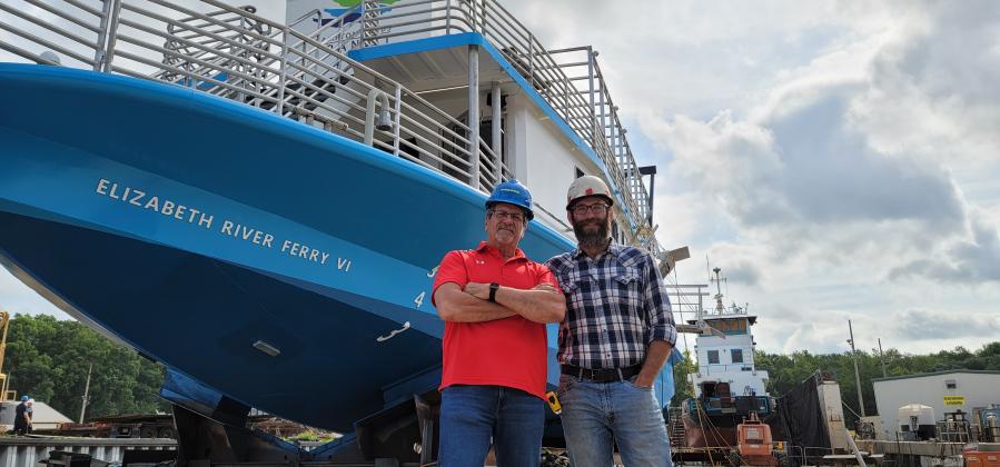 Mike Perez, left, operation projects and contracts administrator for Hampton Roads Transit, and Ben Zeman, St. Johns Ship Building Project Manager, stand in front of the Elizabeth River Ferry VI. (CASMIRA HARRISON/Palatka Daily News)