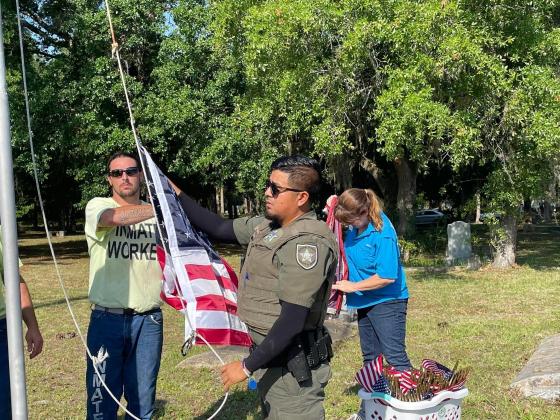 Putnam County Sheriff’s Office officials worked alongside inmate workers and Keep Putnam Beautiful spent Friday cleaning and replacing the American flags at St. Joseph’s Cemetery in Palatka. 