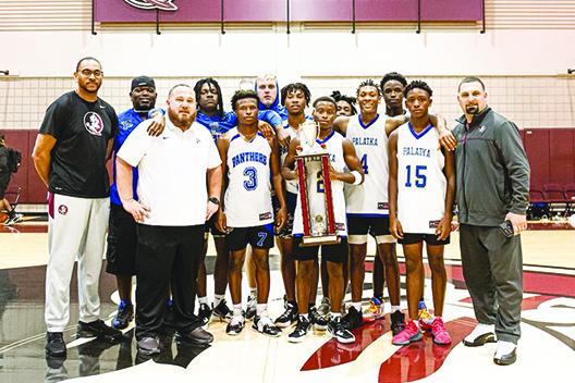 Palatka’s boys basketball team, coached by Bryan Walter (third from left), avenged an early loss to Wilson Academy and won nine straight games to win the Leonard Hamilton Team Camp at Florida State University. (Submitted / Bryan Walter)