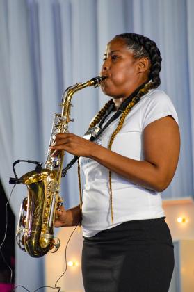 Allana Southernland Prince plays the saxophone during the event.