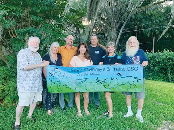 Members of Putnam Blueways & Trails Citizens Support Organization stand together while holding the club’s sign for all to see.