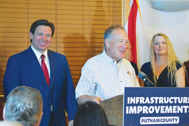 Bass Pro Shops owner Johnny Morris introduces Gov. Ron DeSantis to the crowd gathered Thursday at Corky Bell’s in East Palatka.