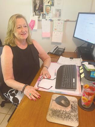 Susan Detar, the founder and owner of The Pink Door in Palatka, sits at her desk to discuss the need for her business, which provides bras to women who have had breast surgery.