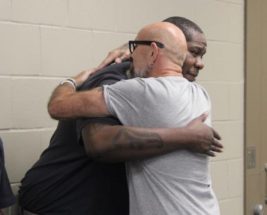 Recovery pod inmate Johnell Williams embraces recovery specialist Ronnie Tomas during a celebration of inmates' progress at the Putnam County Jail last week.