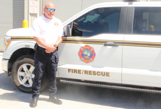 Fire Chief Chad Hutchinson stands with his Putnam County Fire Rescue truck outside a fire station Wednesday morning. 