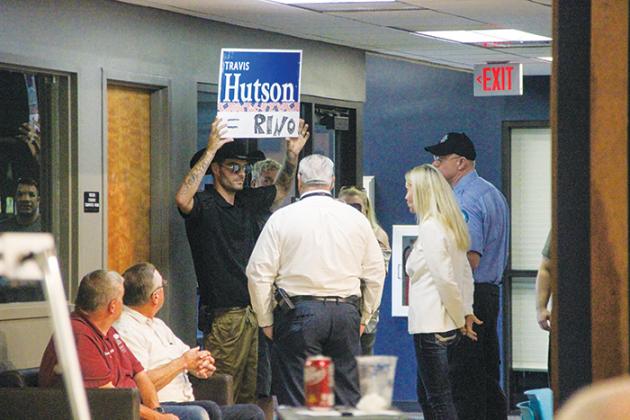 A protester is escorted out by members of the Putnam County Republican Club and St. Johns River State College security Tuesday as he protests state Sen. Travis Hutson’s visit to the college.